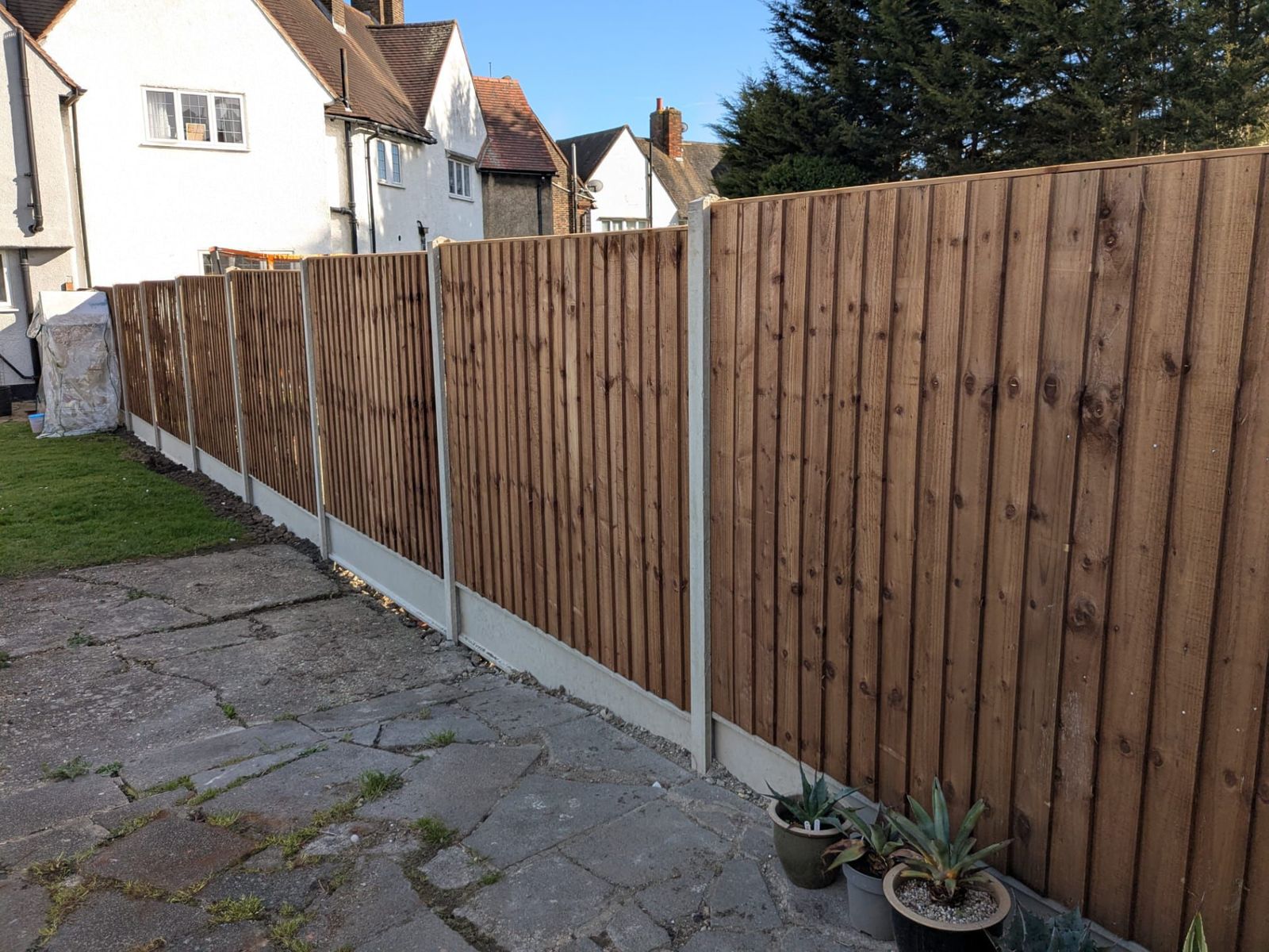 Long run of new closeboard fencing with concrete posts