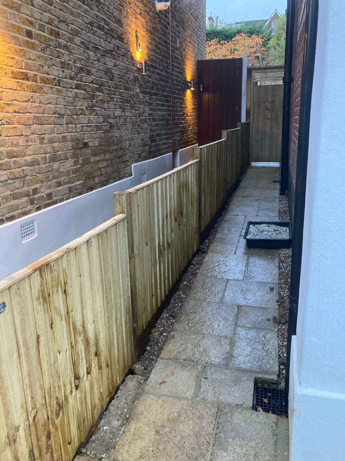 Completed side passage with new fencing, gate, paving and lighting